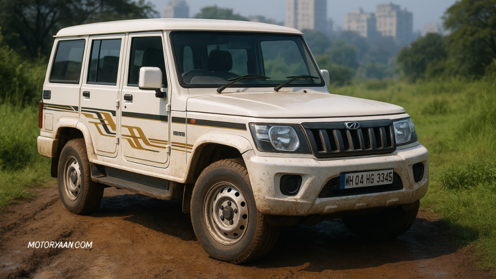 Front and side view of the Mahindra Bolero Bold Edition 2025 parked on a muddy road with rugged styling and dark chrome accents