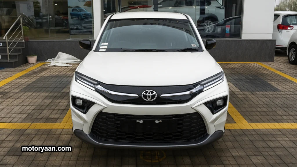 Front view of 2025 Toyota Hyryder E base model with halogen headlights and chrome Toyota badge