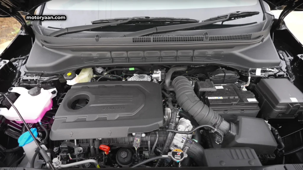 Close-up view of Kia Carens Clavis HTE Optional 2025 engine bay with 1.5L turbo petrol engine