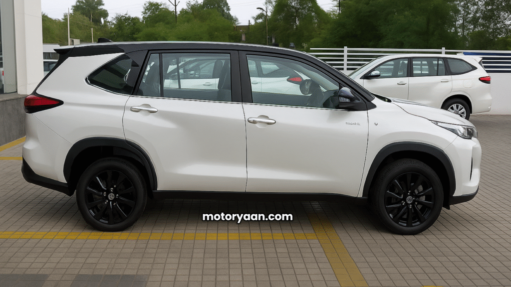 2025 Toyota Innova Hycross Exclusive Edition side profile with blacked-out alloy wheels, chrome door cladding, and dual-tone roof