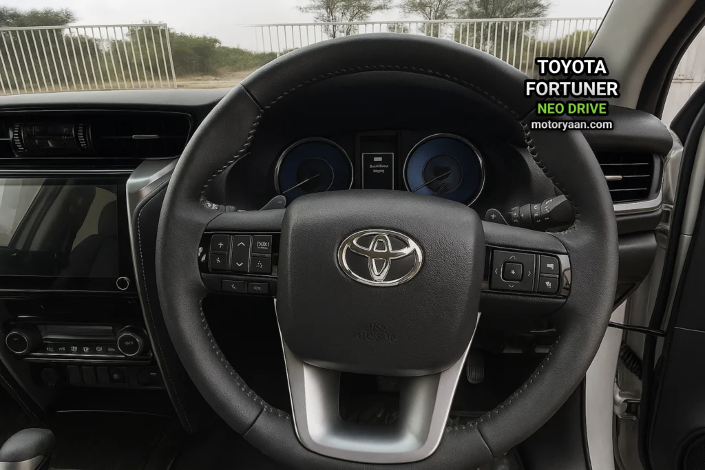 Toyota Fortuner Neo Drive steering wheel with mounted controls, infotainment screen, and instrument cluster.