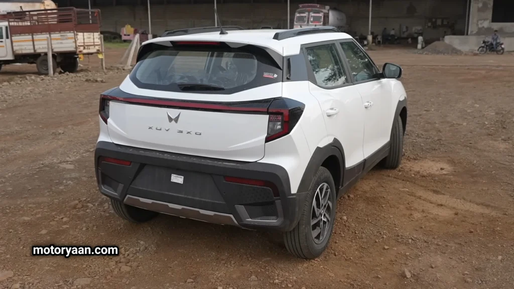 Rear view of Mahindra XUV-3XO SUV with connected tail lamp and roof spoiler.