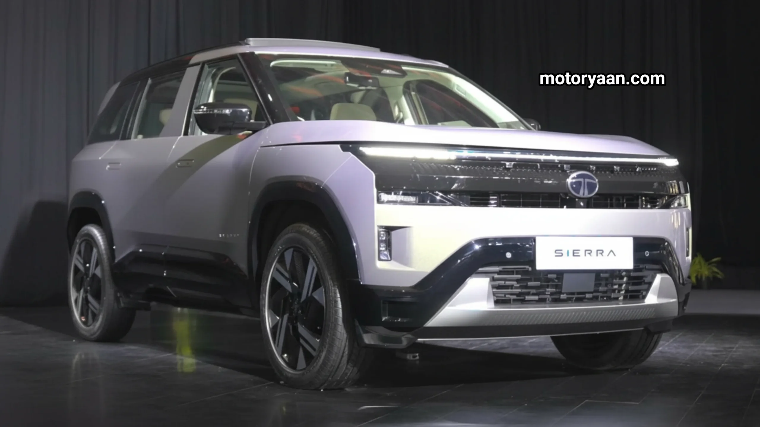 2025 Tata Sierra Accomplished Plus front and side profile showcasing slim LED headlights and premium SUV stance.