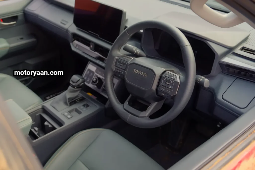 New Toyota HiLux front interior dashboard infotainment system and instrument cluster.