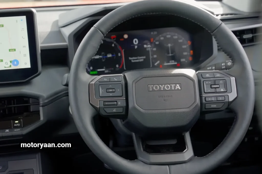 New Toyota HiLux steering wheel with mounted audio and cruise control buttons.