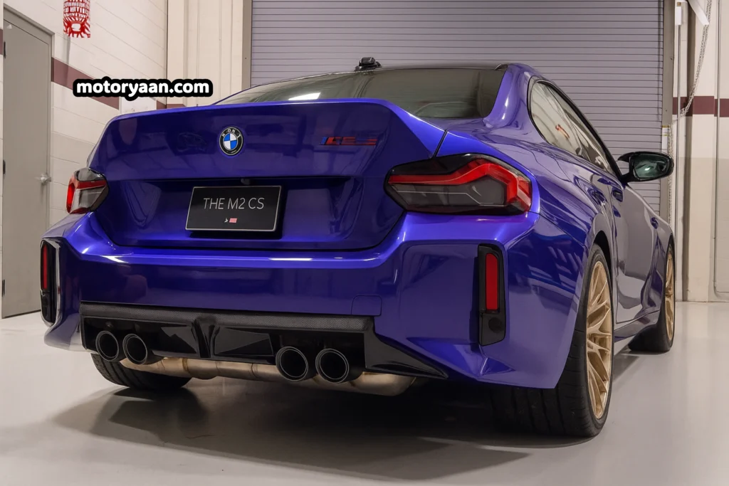 2026 BMW M2 CS rear profile with carbon fiber spoiler and quad exhaust