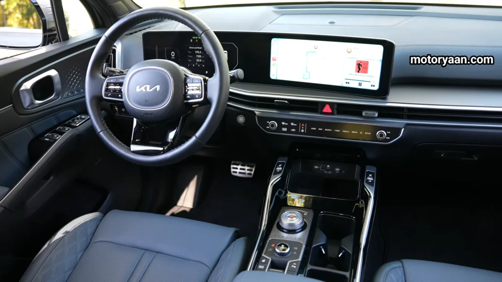 Full front interior including steering wheel, dashboard, center console, and seats for the Kia Sorento Hybrid Complete Technical Review.