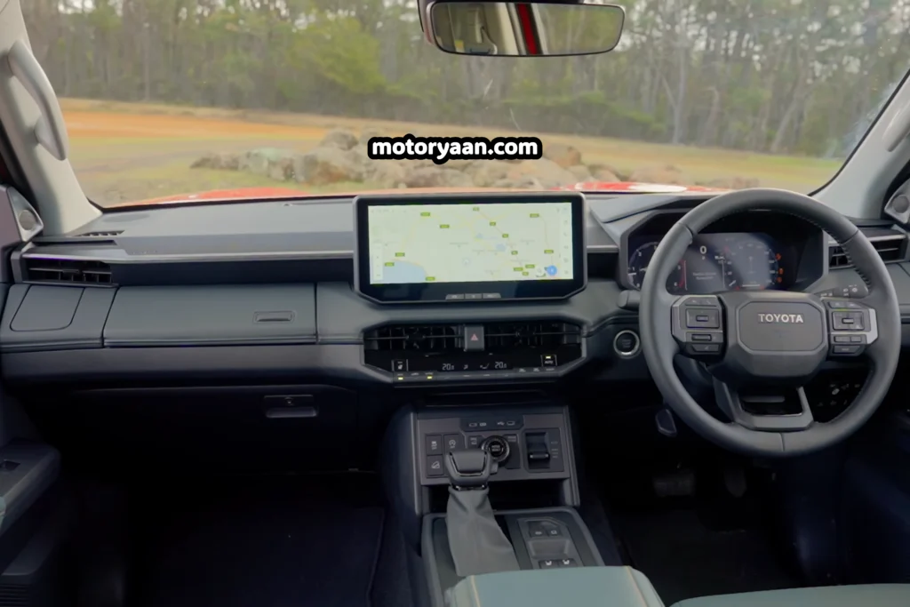 2026 Toyota Hilux complete dashboard with steering wheel, infotainment system, and instrument cluster.