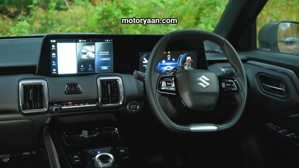 Suzuki Evitara full front interior with steering wheel, instrument cluster, and infotainment in the Suzuki Evitara Review
