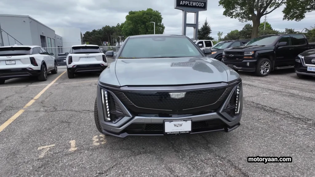 2026 Cadillac Lyriq V front profile showcasing illuminated grille and vertical LED headlights