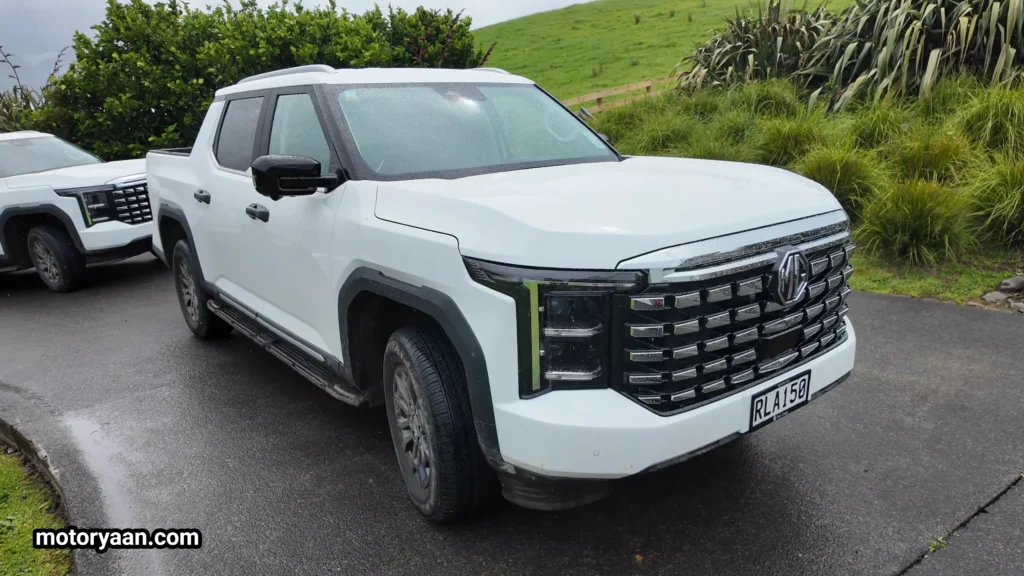 2026 MG U9 Review showing front three-quarter angle with bold grille, LED headlights, and muscular side profile