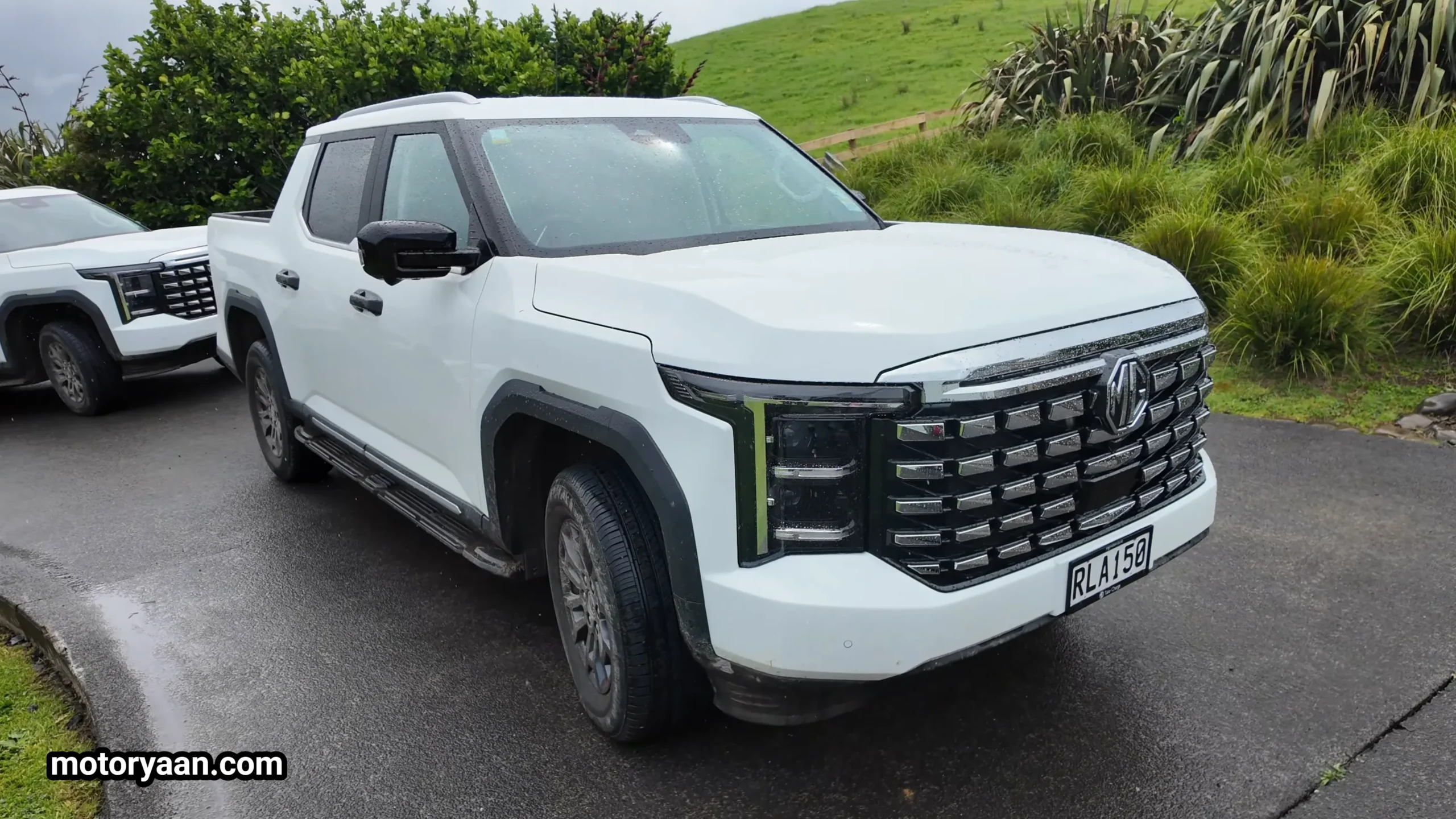 2026 MG U9 Review showing front three-quarter angle with bold grille, LED headlights, and muscular side profile