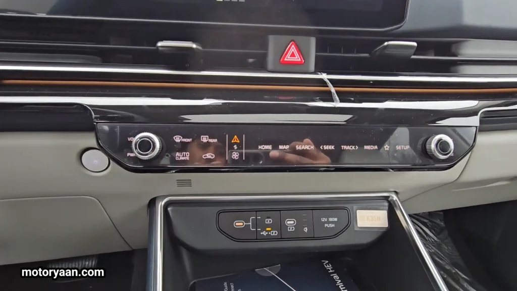 2026 Kia Carnival SX Prestige climate control panel with AC vents and charging ports