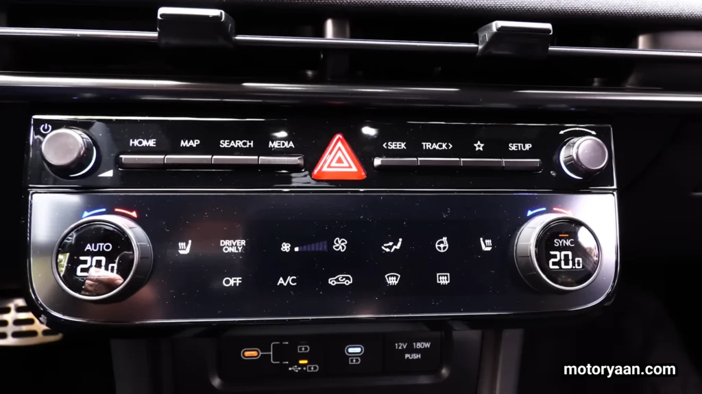 2026 Hyundai Tucson Hybrid climate control panel with physical AC buttons