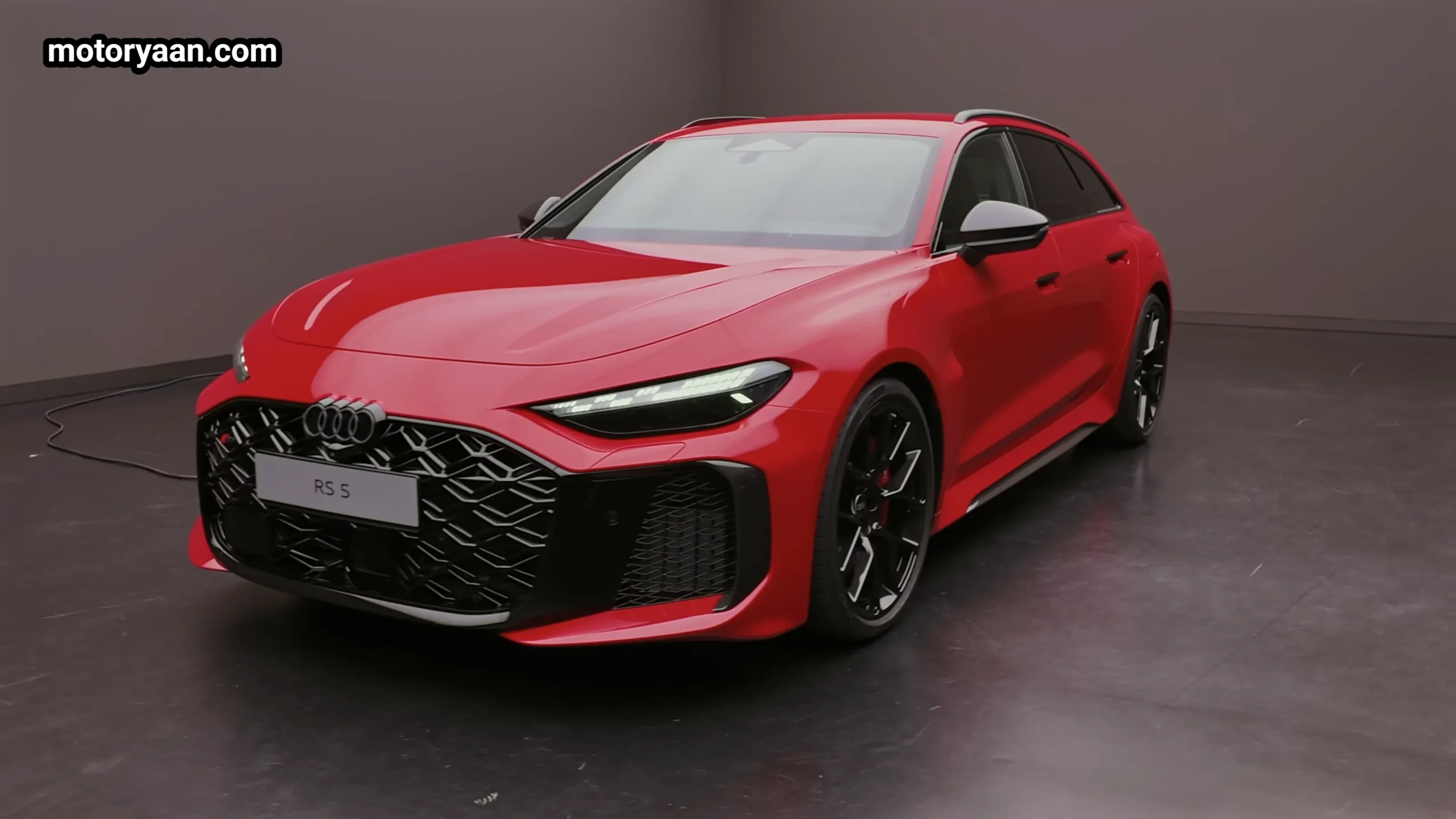 2026 Audi RS5 Avant front three quarter profile showing Singleframe grille and wide stance