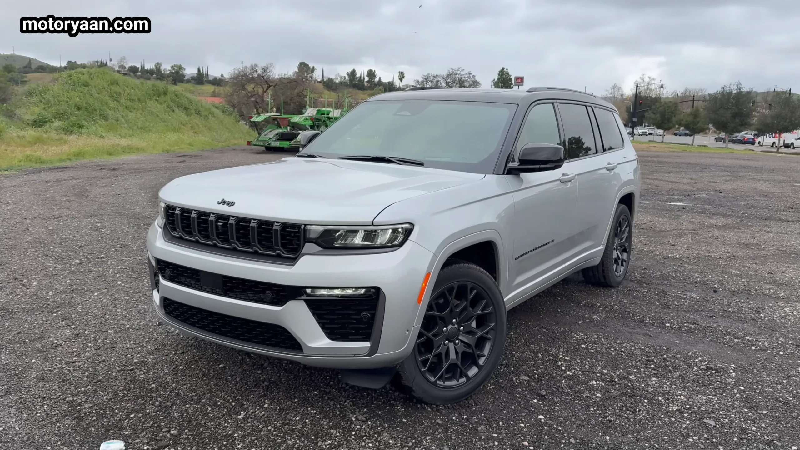 2026 Jeep Grand Cherokee L front three quarter view showing grille, LED headlights and side profile