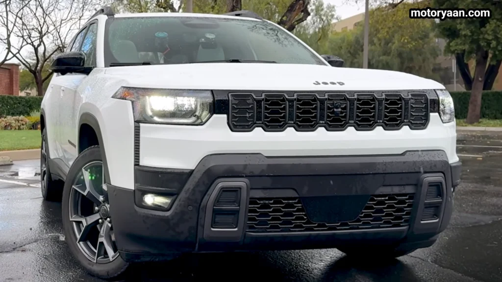 2026 Jeep Cherokee Hybrid front three quarter view showing grille and side profile