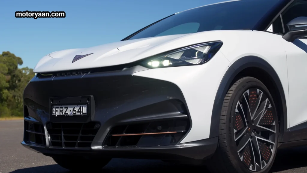 Cupra Tavascan VZ front profile with sharp LED headlamps and illuminated Cupra badge