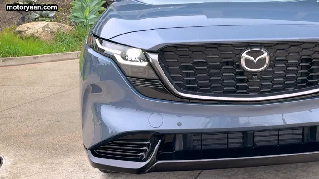 close up of 2026 Mazda CX 5 front grille and LED headlight detail