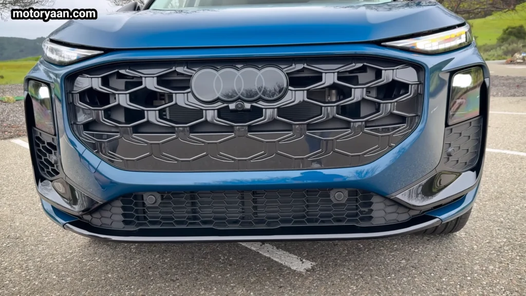 2026 Audi Q3 close up front fascia with single frame grille LED headlights and Audi four rings logo