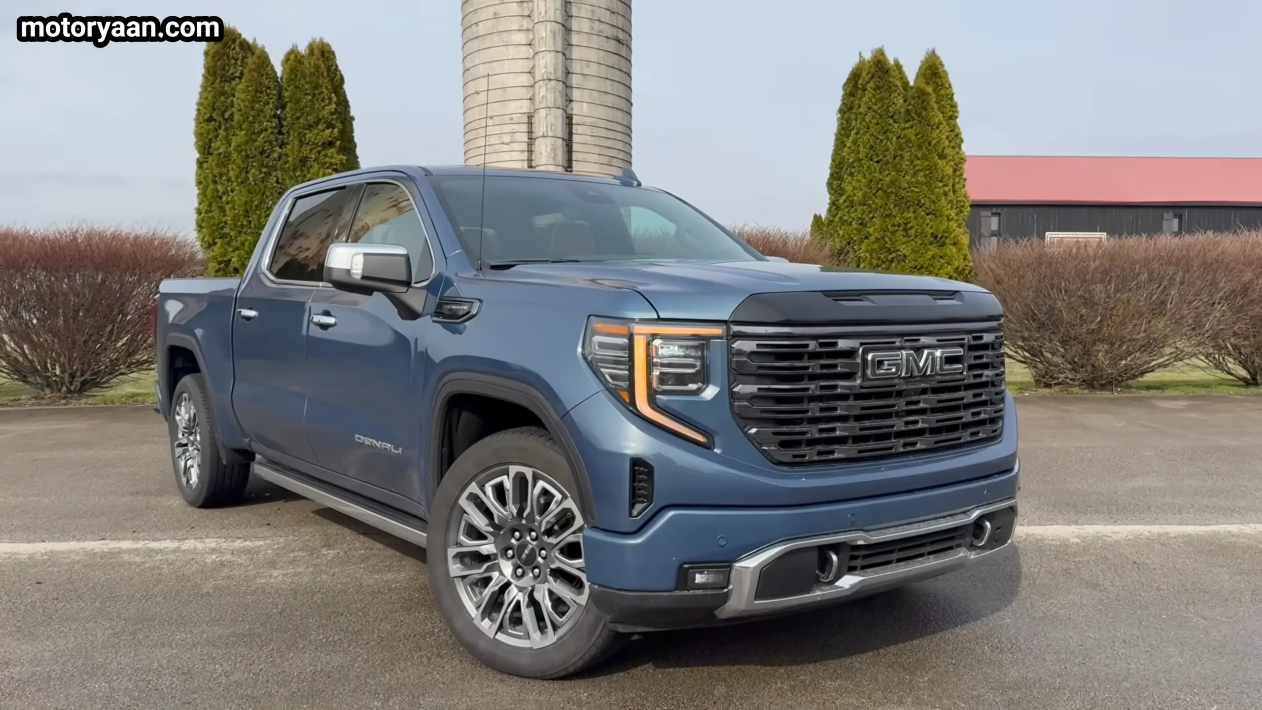 2026 GMC Sierra 1500 Denali Ultimate front three quarter view with premium grille and 22 inch alloy wheels