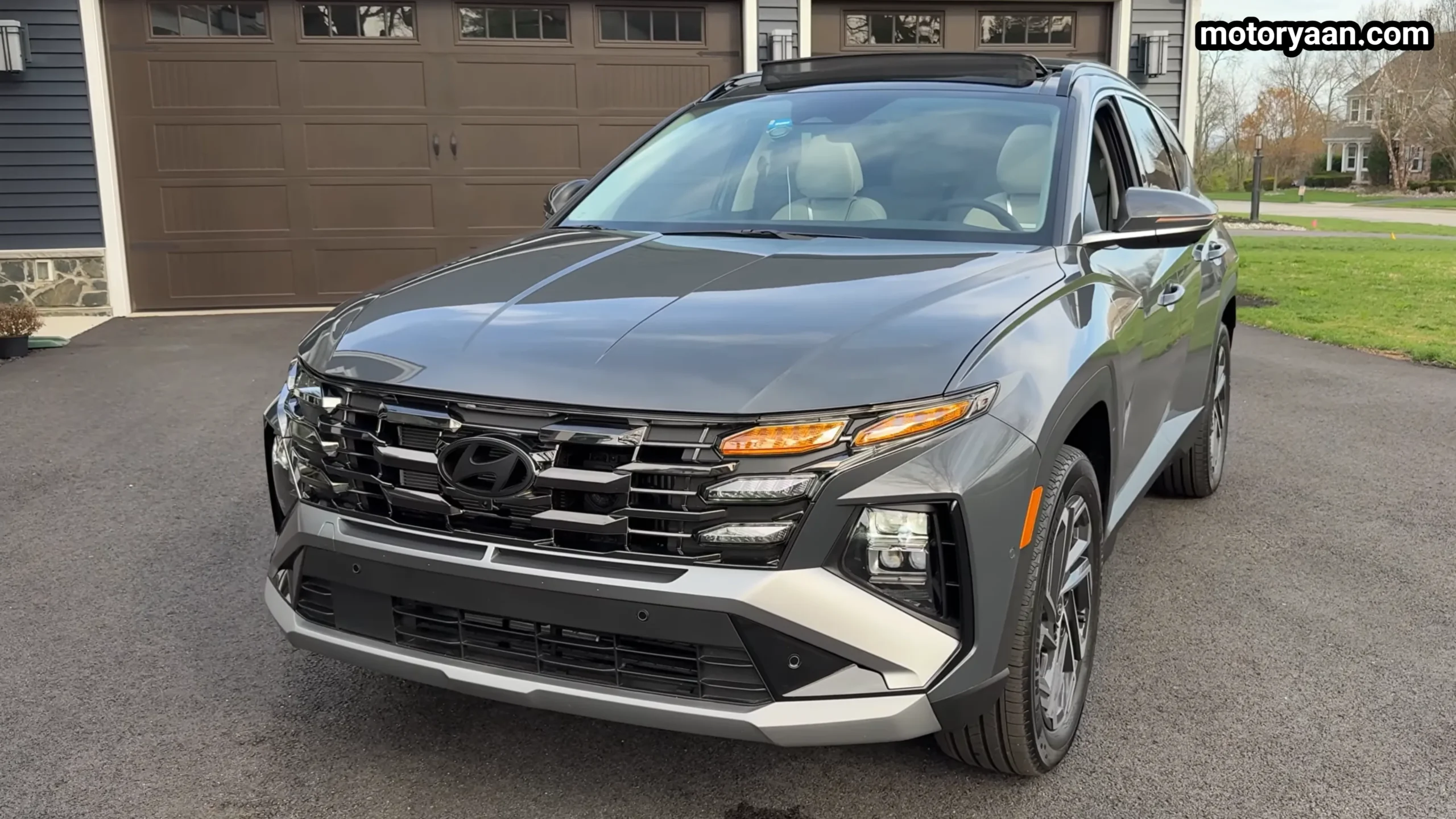 2026 Hyundai Tucson Hybrid front three quarter view showing grille and side lines