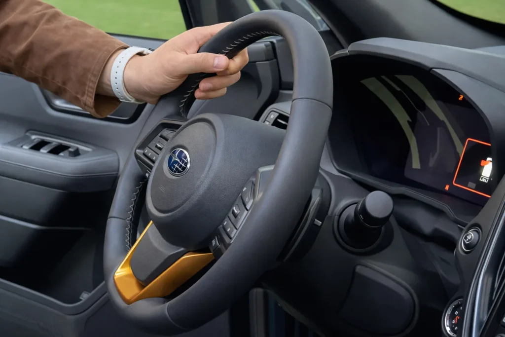 2027 Subaru Forester Wilderness Hybrid steering wheel with mounted controls and Subaru logo